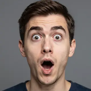 A portrait capturing genuine surprise — raised eyebrows, wid
