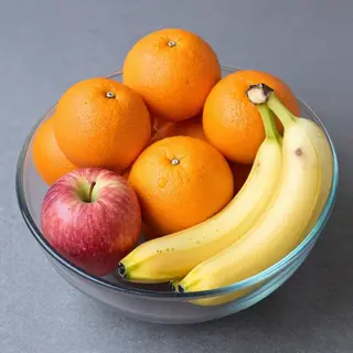 A fruit bowl containing exactly 3 bananas, 4 oranges, and 2 