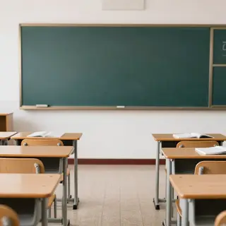 A classroom with desks and a chalkboard but no students