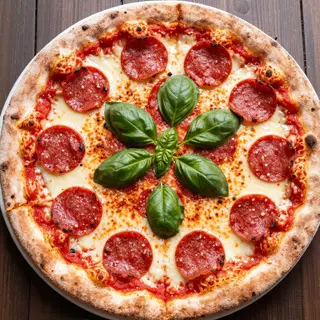 A pepperoni pizza with tomato sauce, basil, and crust but ab