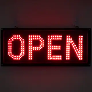 The word 'OPEN' displayed on a red LED sign with glowing pix