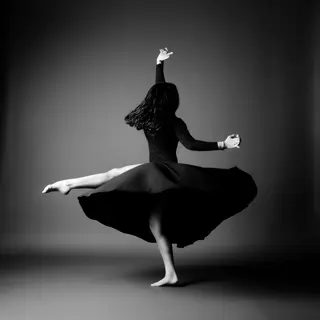 A dancer in a dynamic spin, dress flowing outward with one l