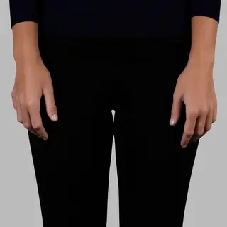 A person standing with both hands visible at their sides, fi
