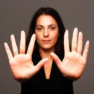 A woman holding her hands out in front of her palms-up, all 