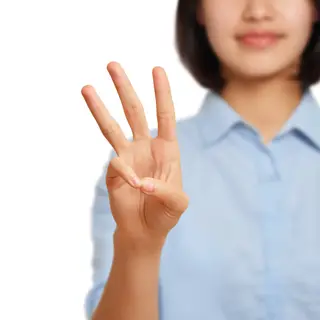 A person counting to three on their fingers, with index, mid