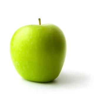 A ripe green apple on a seamless white background with soft 