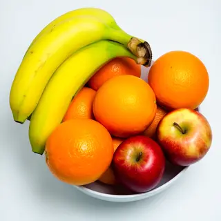 A fruit bowl containing exactly 3 bananas, 4 oranges, and 2 