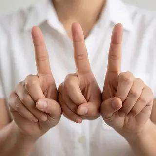 A person counting to three on their fingers, with index, mid