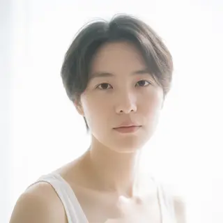 A high-key portrait of a person against a bright white backg