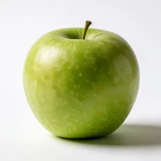 A ripe green apple on a seamless white background with soft 