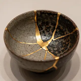 A Japanese kintsugi bowl — cracked ceramic repaired with vis