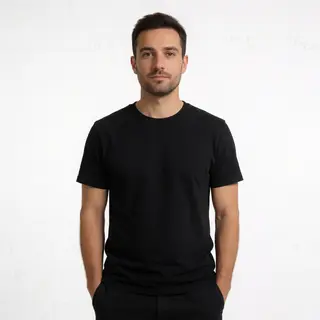A man standing straight facing the camera, hands in pockets,