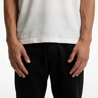 A person standing with both hands visible at their sides, fi