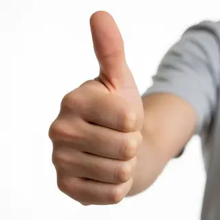 A hand giving a thumbs-up with four fingers curled and thumb