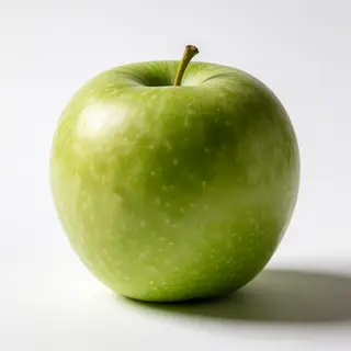 A ripe green apple on a seamless white background with soft 