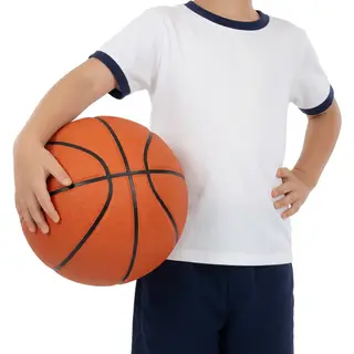 A child holding a basketball, both at correct relative sizes