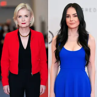 Two women standing side by side: one with short blonde hair 