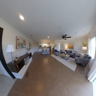 A wide-angle shot of a modern living room interior showing e