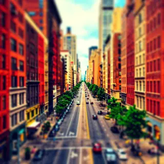 A tilt-shift photograph of a city street making real-life lo