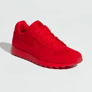 A single red sneaker on a clean white background with soft s