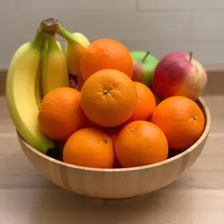 A fruit bowl containing exactly 3 bananas, 4 oranges, and 2 