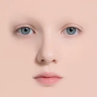 A human face with eyes, nose, and mouth but no eyebrows