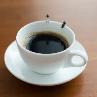 A tiny person standing on the rim of a coffee cup, looking d