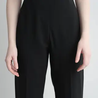 A person standing with both hands visible at their sides, fi