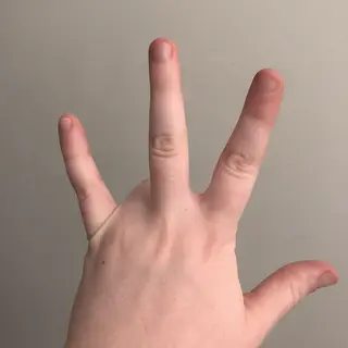 A person counting to three on their fingers, with index, mid