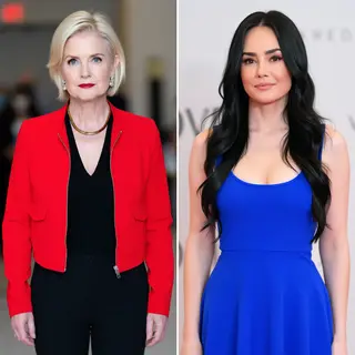 Two women standing side by side: one with short blonde hair 