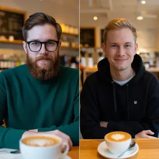 Two men at a cafe: one with a beard and glasses wearing a gr
