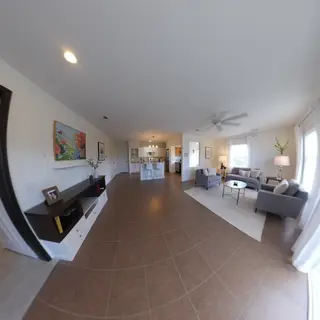 A wide-angle shot of a modern living room interior showing e