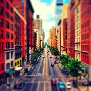 A tilt-shift photograph of a city street making real-life lo