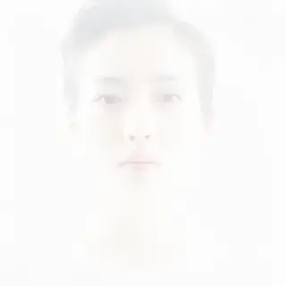 A high-key portrait of a person against a bright white backg