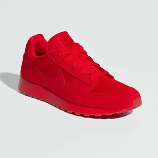 A single red sneaker on a clean white background with soft s