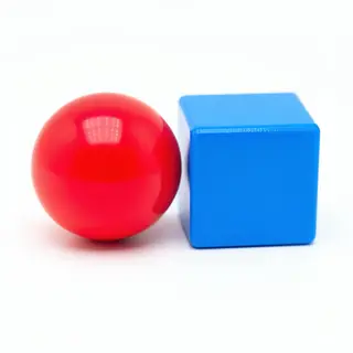 A red ball and a blue cube sitting side by side on a white s