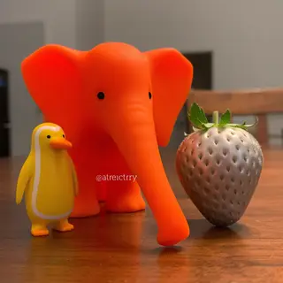 An orange elephant, a yellow penguin, and a silver strawberr