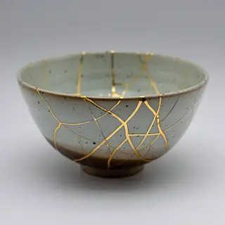 A Japanese kintsugi bowl — cracked ceramic repaired with vis