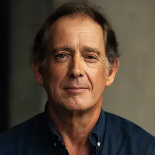 A portrait of a middle-aged man with a calm, serious express