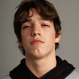 A headshot of a teenager with a relaxed, neutral face