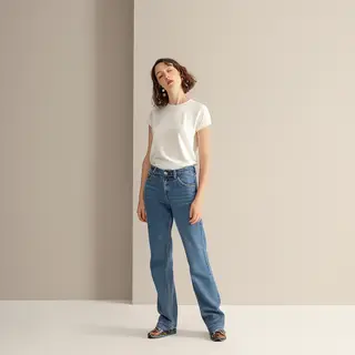 A woman standing upright in a relaxed pose, arms at her side