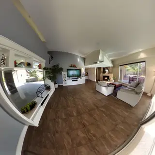 A wide-angle shot of a modern living room interior showing e