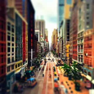 A tilt-shift photograph of a city street making real-life lo