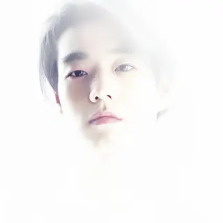 A high-key portrait of a person against a bright white backg