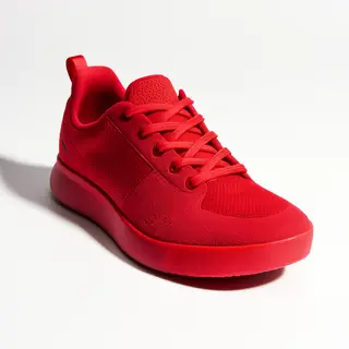 A single red sneaker on a clean white background with soft s