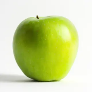 A ripe green apple on a seamless white background with soft 