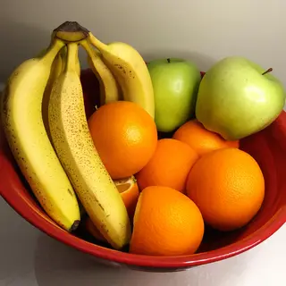 A fruit bowl containing exactly 3 bananas, 4 oranges, and 2 