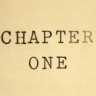 The word 'CHAPTER ONE' typed on aged paper with a vintage ty