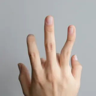 A person counting to three on their fingers, with index, mid