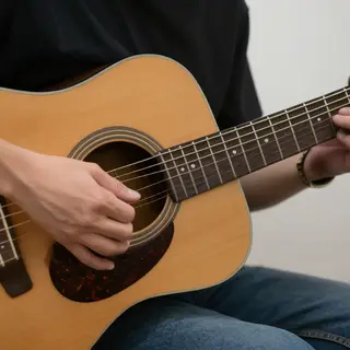 A person playing an acoustic guitar with left hand on the fr